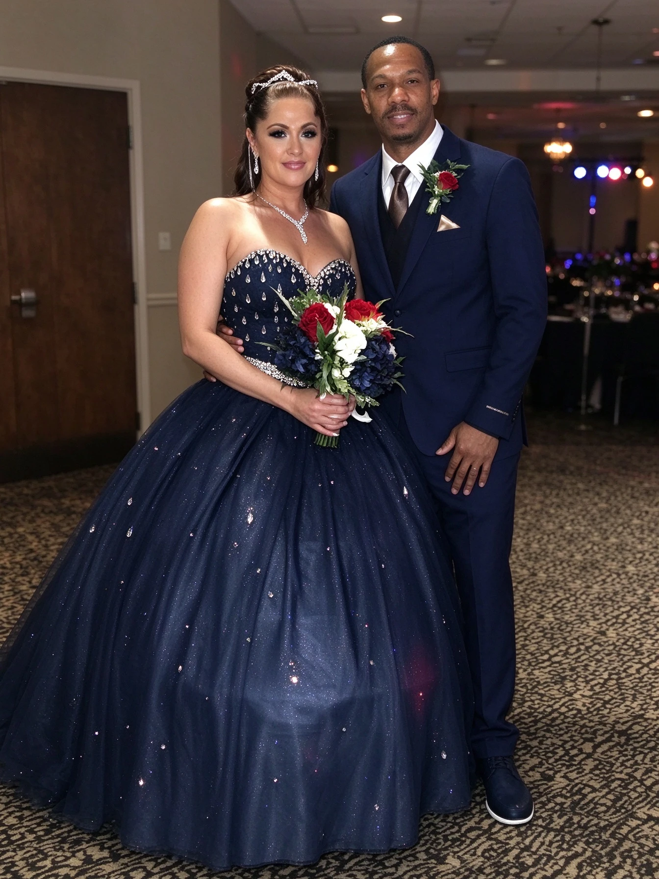 Bride and groom wearing coordinated navy wedding looks