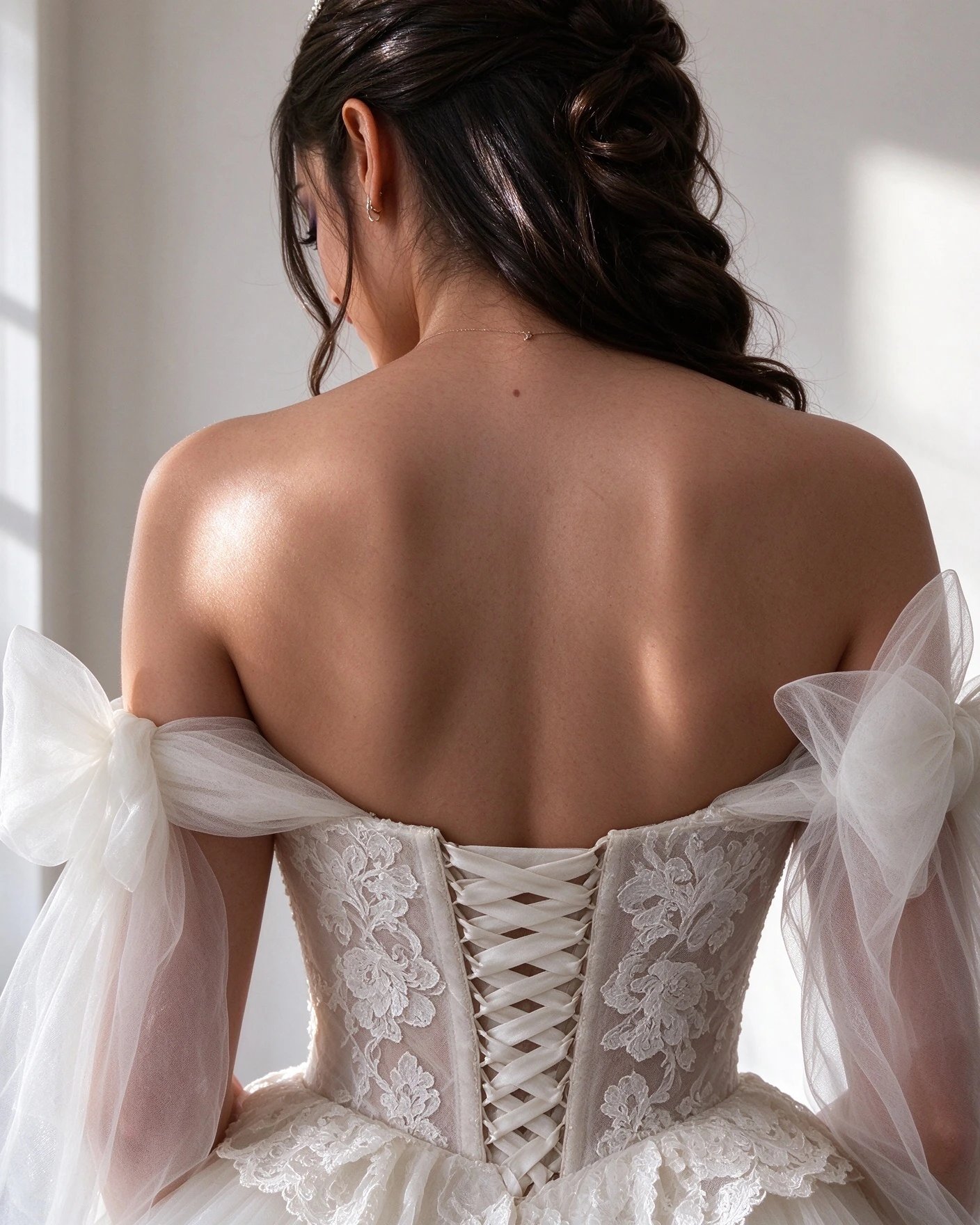 Lace-up corset back framed by removable tulle bow sleeves