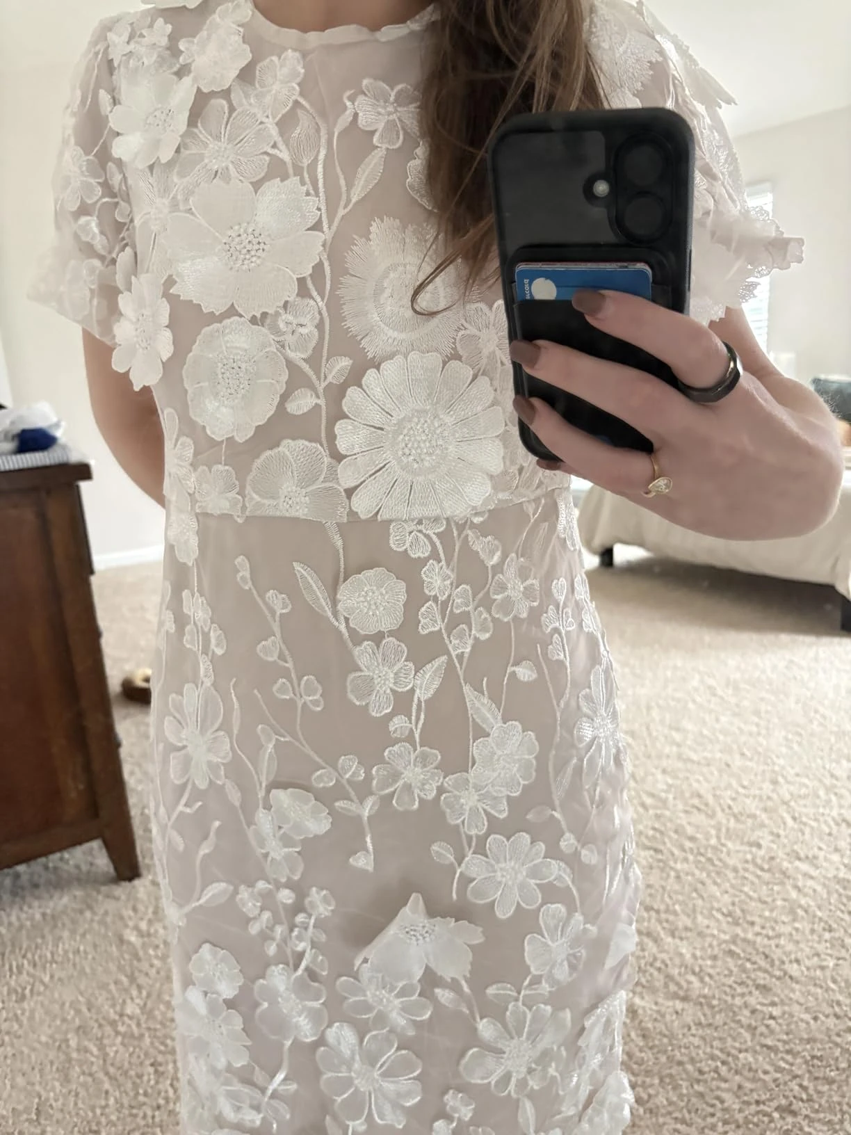 Phone selfie showing the floral lace texture and fabric of my rehearsal dress