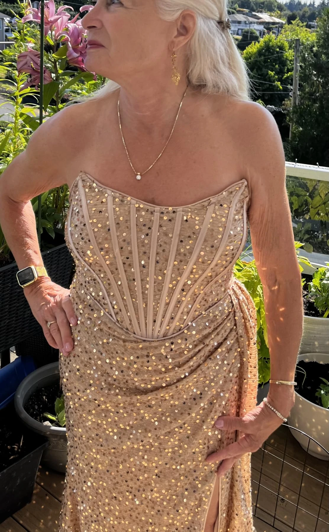 Woman posing in medium gold sequin gown
