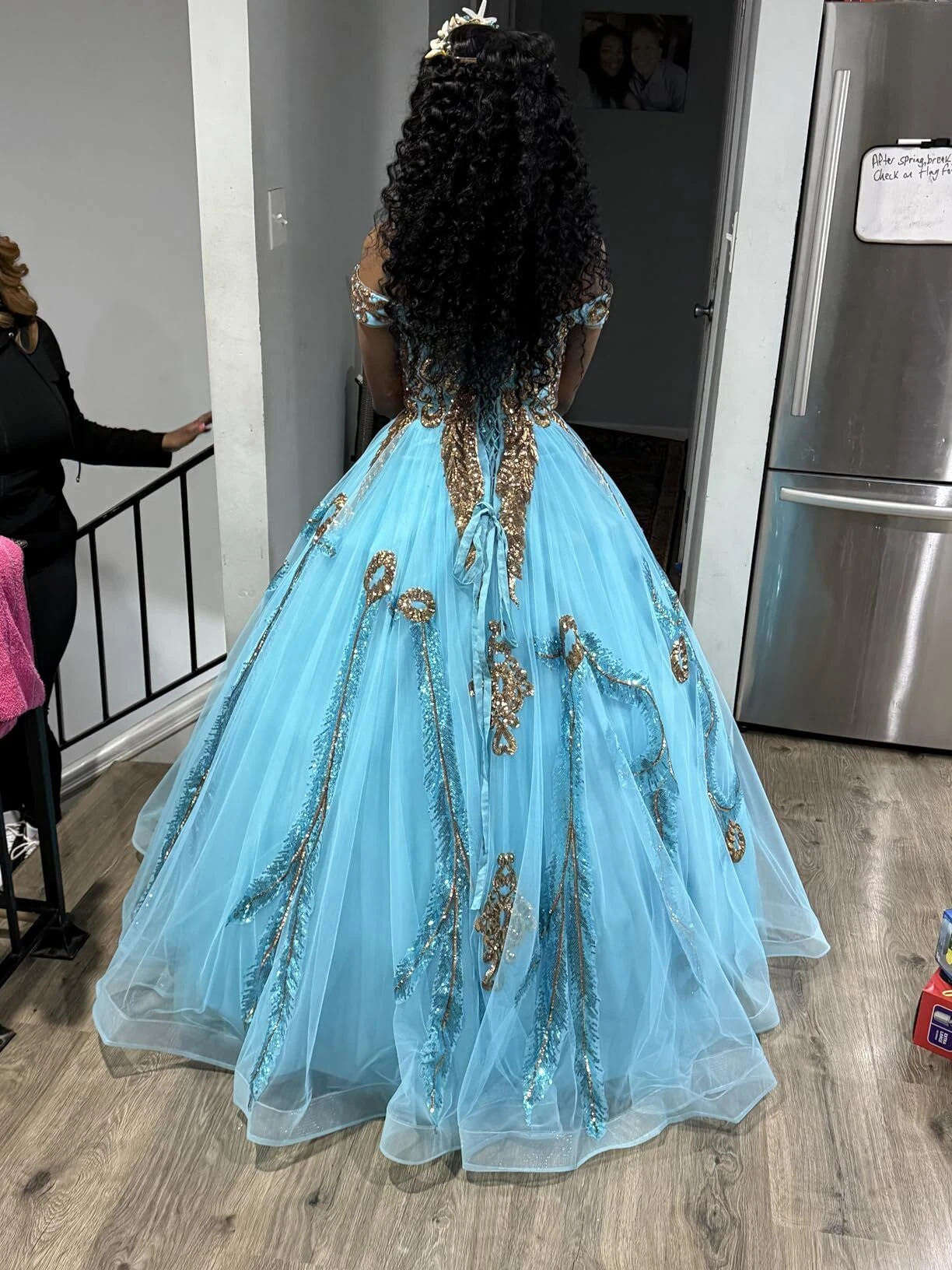 Corset lace up back detail of a turquoise ball gown