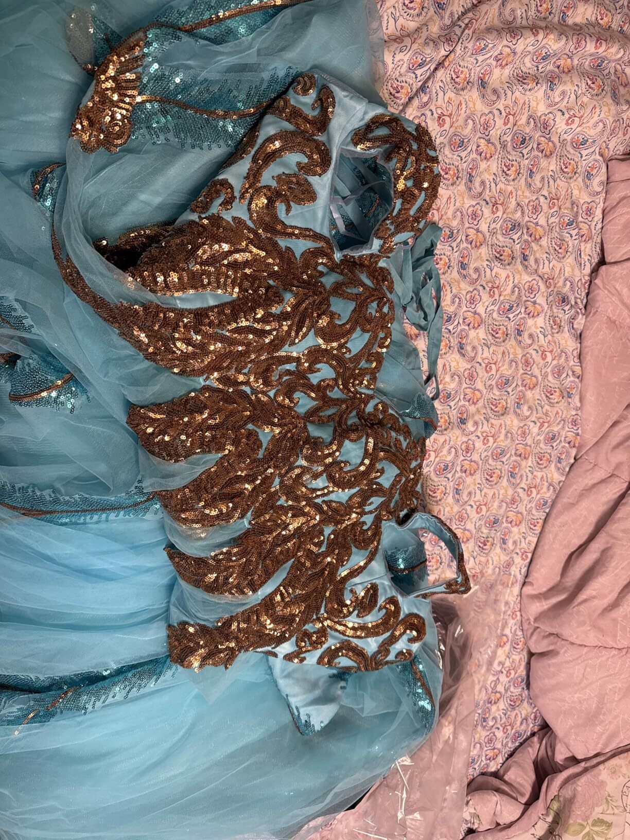 Close up of gold sequin embellishment on turquoise prom gown