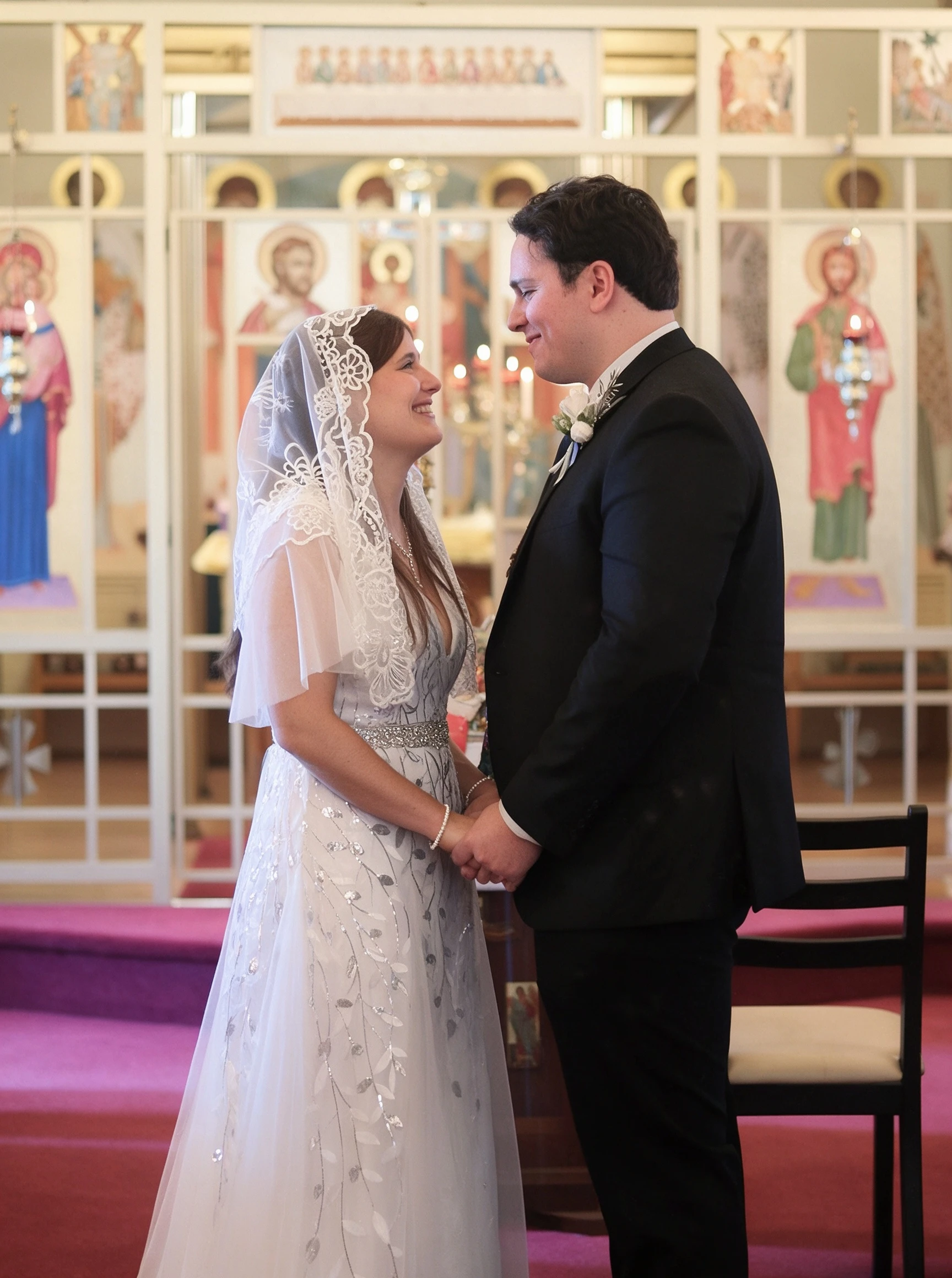 Lauren holding hands with Dan during the wedding ceremony in her sequined leaf gown
