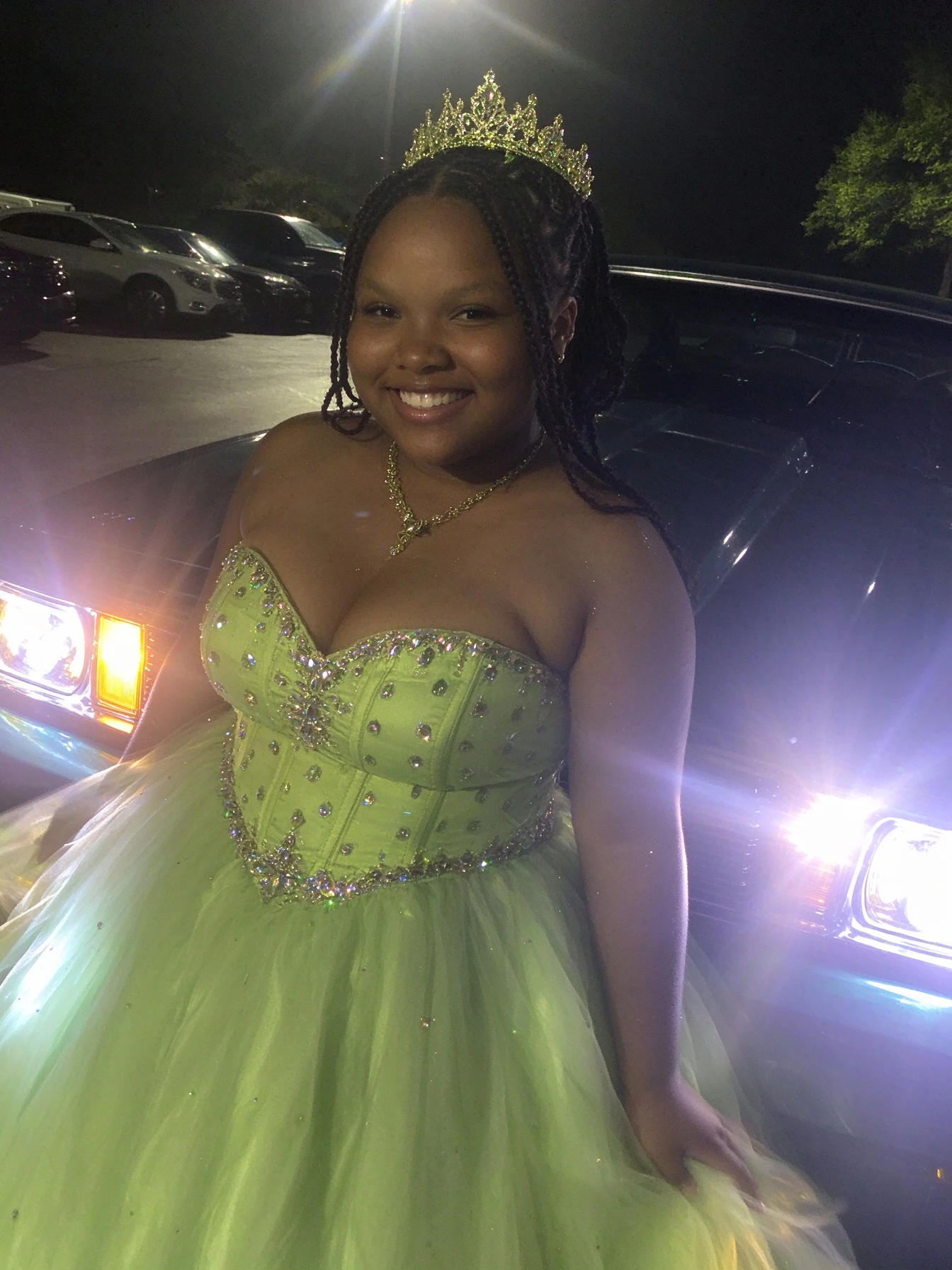 Lime green rhinestone bodice sparkling in headlights during Sweet 16 night photos