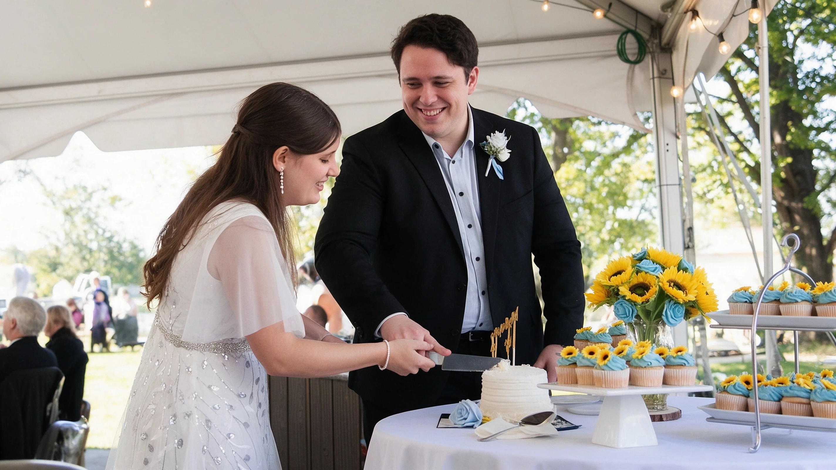 Lauren cutting the wedding cake in her silver embroidered gown