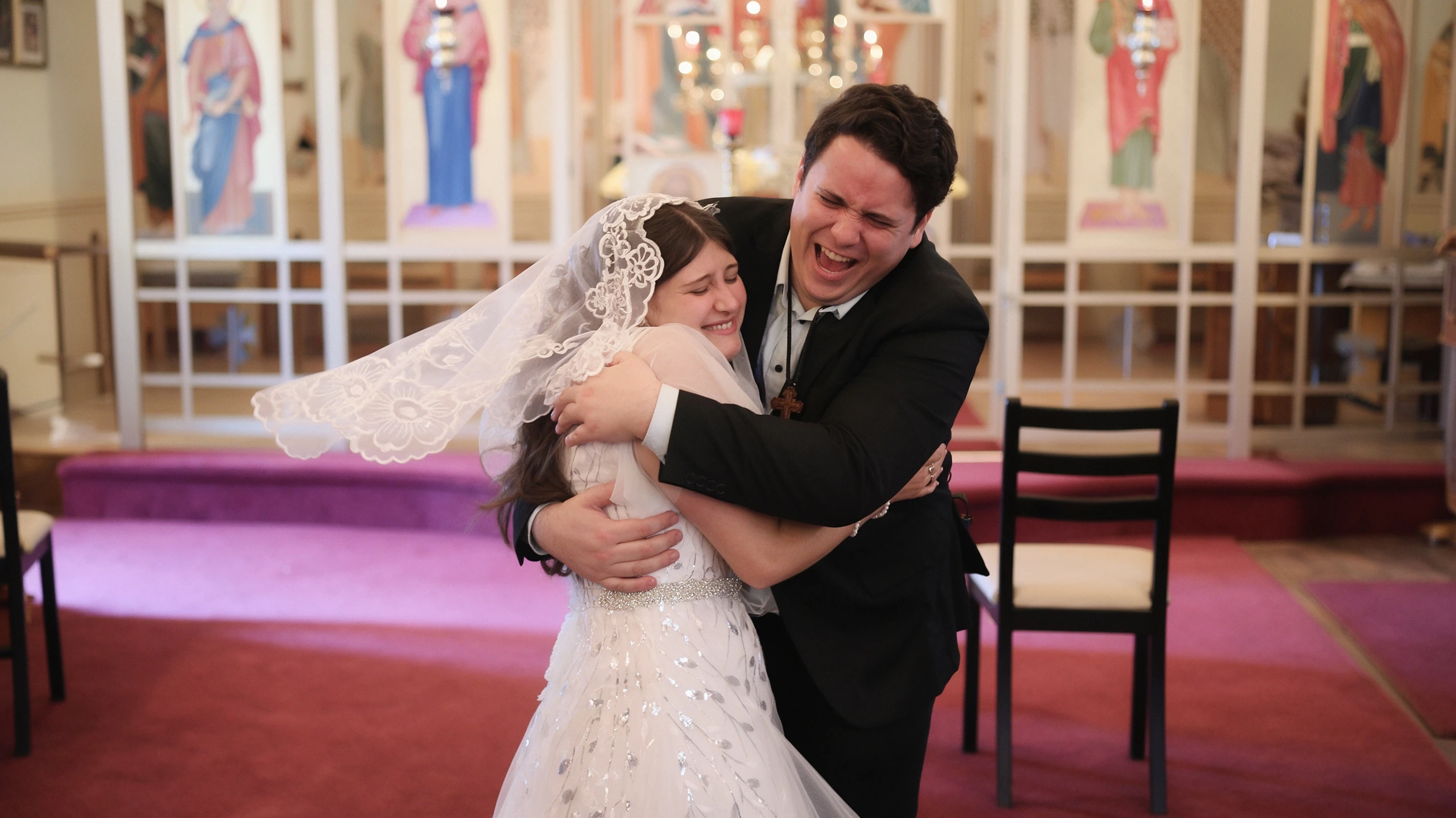 Lauren and Dan sharing a tender hug at the altar during their Byzantine wedding