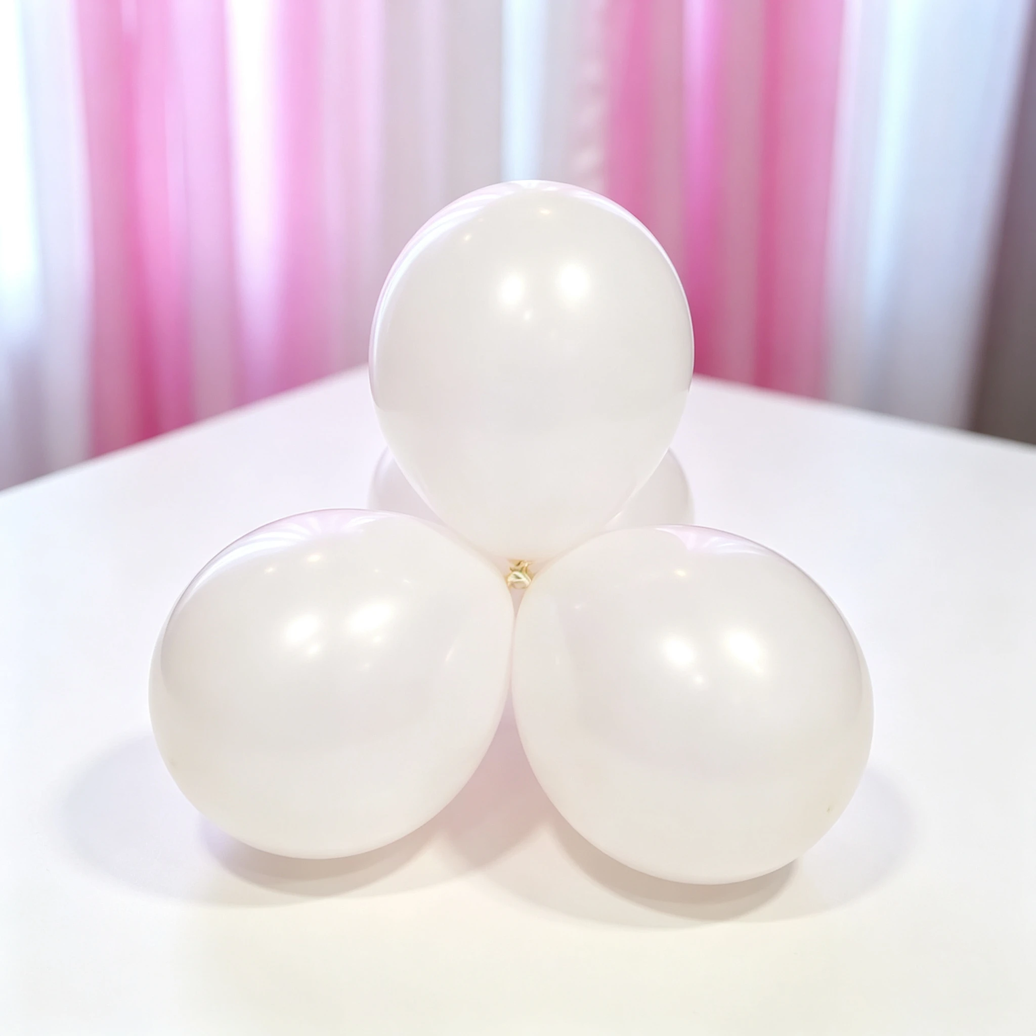 White balloons beside a birthday party table