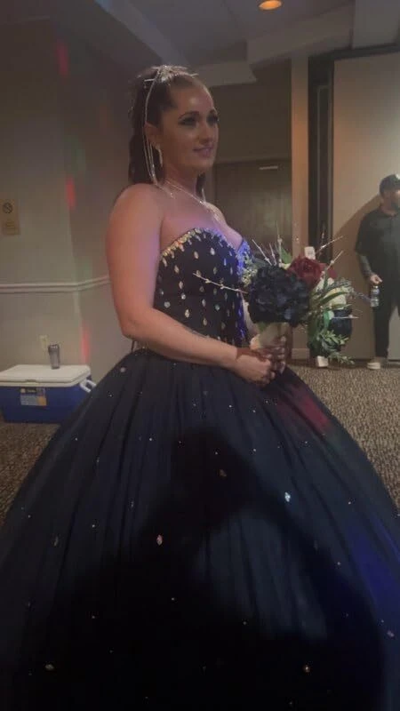 Bride waiting to walk down the aisle in her navy blue gown