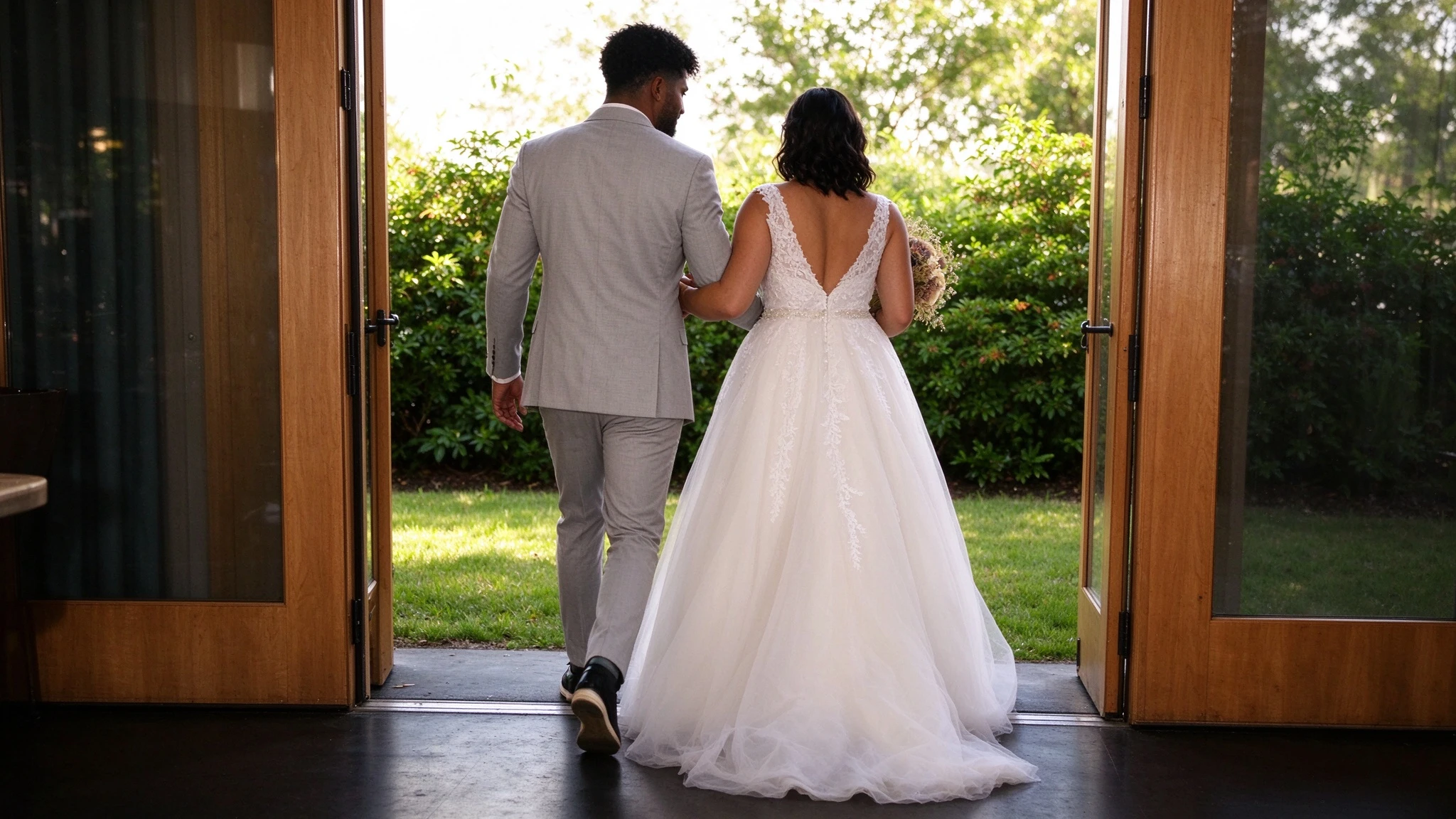 Bride walking through Canvas doors in a flowing tulle wedding dress