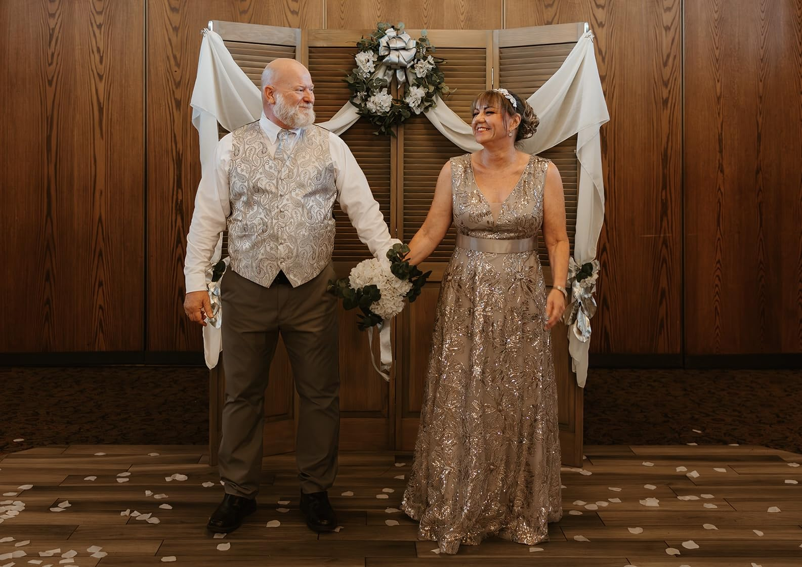 Couple standing hand in hand before their 25 year vow renewal ceremony