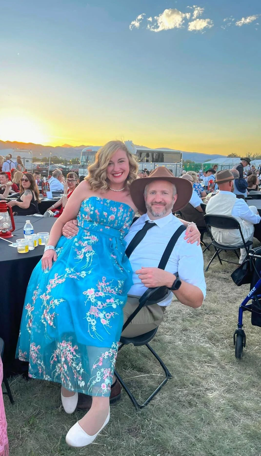 Woman in a cream floral lace A-line dress at a sunset outdoor event gathering