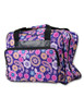 Bernette b05 Academy sewing machine with purple paisley tote bag, front angled view showing carrying case and accessories