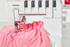 Brother CV3550 machine stitching pink athletic fabric showing double cover stitch capability