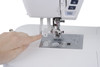 Close-up of the Janome Skyline S7 Anniversary Edition needle plate showing the 9mm stitch width markings, feed dog, and needle drop position guides
