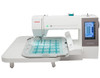 Janome 550e embroidery machine with wide extension table attached, shown from the front