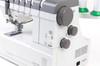 Tension Dials & Controls Detail: A close-up of the right side of the machine highlighting the FINE/STD mode switch, the differential feed dial, the stitch length dial, and the ventilation grille. The "Top Cover Stitch" and "CoverPro 3000 Professional" branding is visible at the bottom. Good for a controls feature callout.