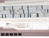 Janome MC9410 QC top storage tray open, showing the built-in stitch reference chart and upper accessory storage