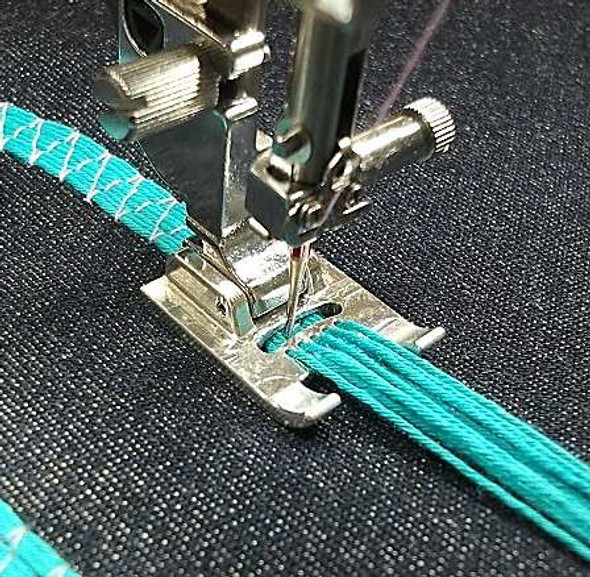 Janome sewing machine foot stitching in 9 cords - spicing up this piece of black fabric