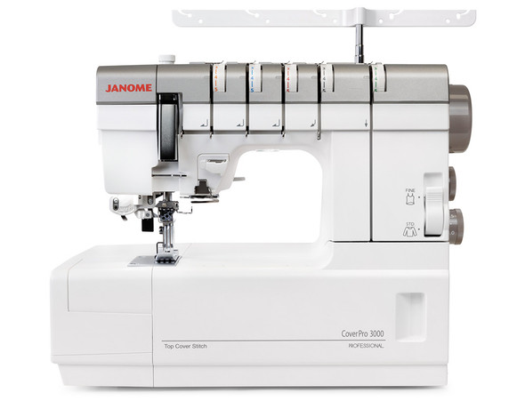 Front View (No Spools): A straight-on front product shot without thread loaded. Shows the full machine face including all five tension dials, the FINE/STD switch, the needle area, and the spool bar. Clean white background — strong candidate for the primary product image.