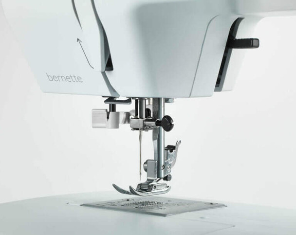 Bernette 33 sewing machine presser foot close-up showing needle and white body detail with tote bag included