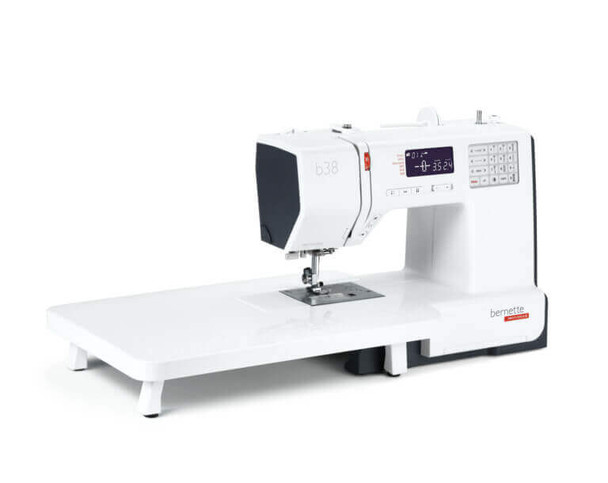 Bernette 38 computerized sewing machine with extension table and black tote bag, white body with LCD display