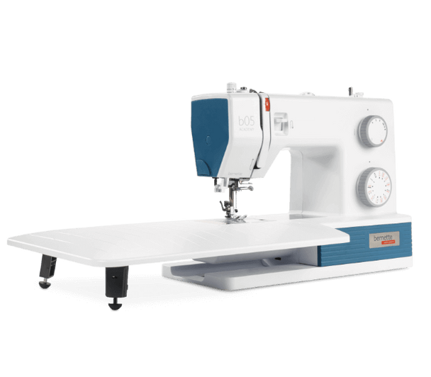 Bernette 05 Academy sewing machine in white with blue accents, includes extension table and tote bag