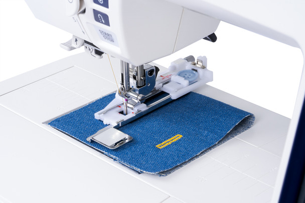 Janome Skyline S7 Anniversary Edition in use, stitching fabric with the AcuFeed Flex dual-feed system engaged