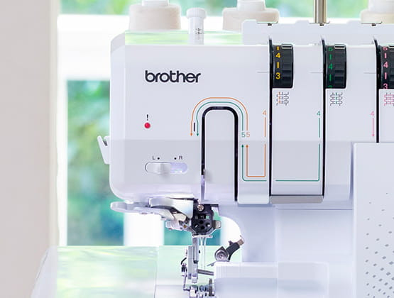 Brother Airflow 3000 serger in bright home sewing space with blue fabric and colorful pillows