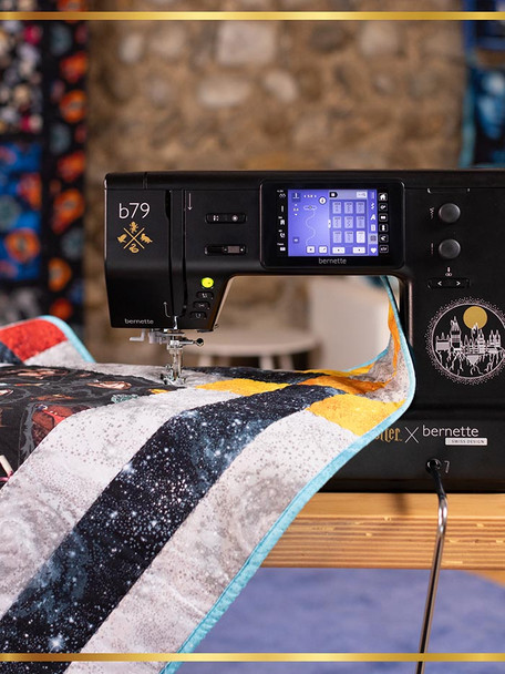 Harry Potter x bernette b79 Special Edition sewing machine quilting a Wizarding World fabric quilt with Hogwarts castle engraving visible on machine body