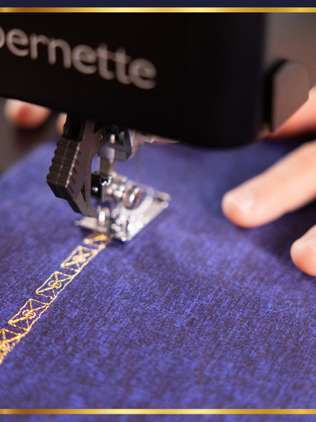 Harry Potter x bernette b79 sewing machine on worktable with Wizarding World quilt, viewed through a stone archway
