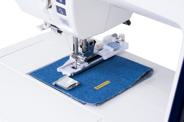 Janome Skyline S7 Anniversary Edition in use, stitching fabric with the AcuFeed Flex dual-feed system engaged