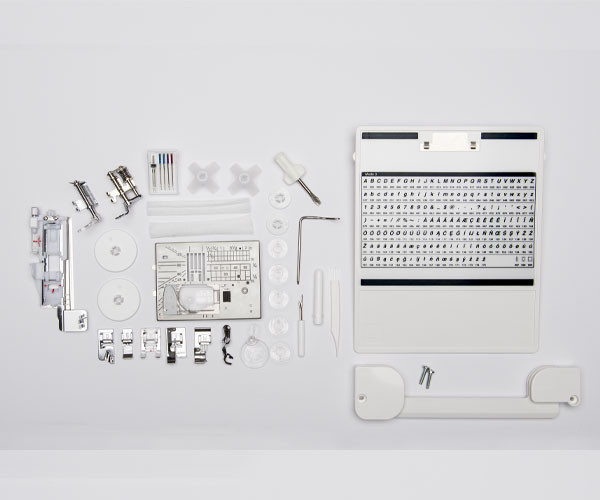 Elna EF72 standard and bonus accessories laid out, including walking foot, free-motion quilting bobbin case, presser feet, and quilting tools