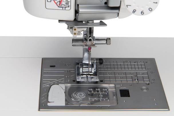 Close-up of the Elna EF72 needle plate showing 9mm stitch width markings, feed dog system, and needle drop position