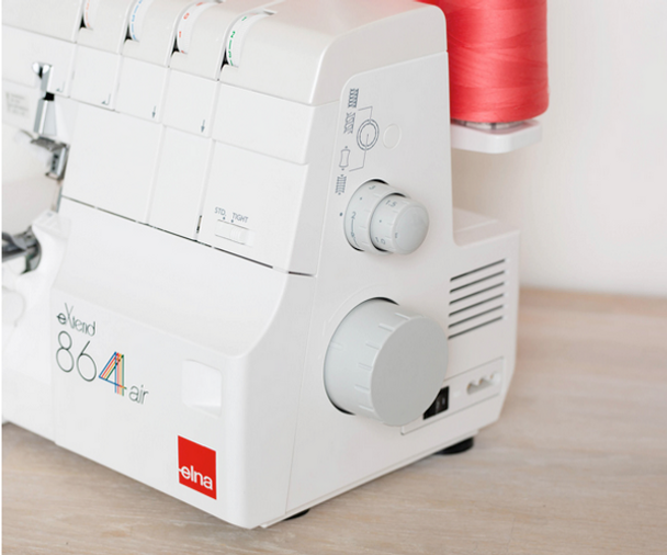 Elna eXtend 864air with Bonus Package (Compare to Janome AirThread 2000D) on a table