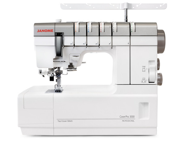 Front View (No Spools): A straight-on front product shot without thread loaded. Shows the full machine face including all five tension dials, the FINE/STD switch, the needle area, and the spool bar. Clean white background — strong candidate for the primary product image.