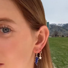 Game day ear stack with navy mini bolt and white baby star huggie earrings
