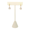 Gold open star huggie hoop earrings on display stand