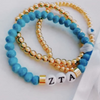 zeta tau alpha sorority bracelet and gold beaded bracelet