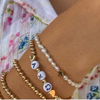 wearing chi omega gold beaded sorority bracelet