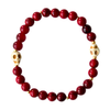 red quartz gemstone with two white turquoise skull beads
