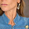 Model wearing The Dolly Stack rhinestone safety pin and butterfly huggie earrings