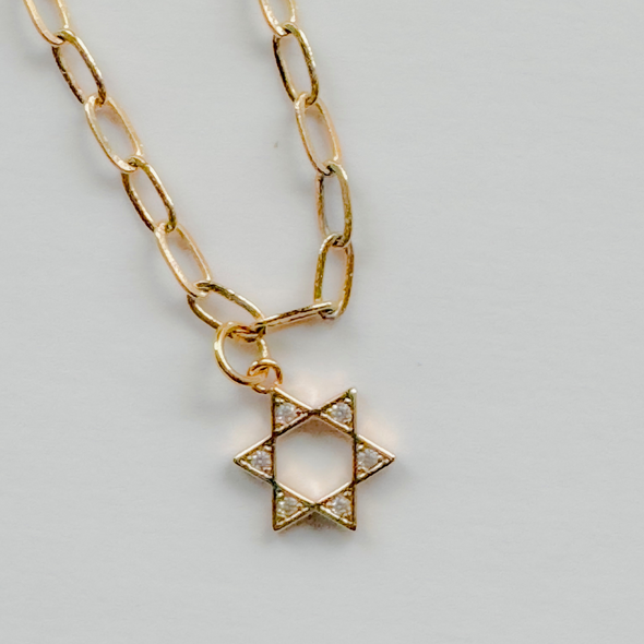 close up of cz pave star of david charm on necklace