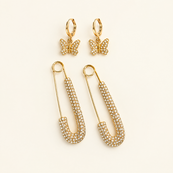 The Dolly Stack gold rhinestone safety pin earrings and glitzy butterfly huggie hoop earrings set