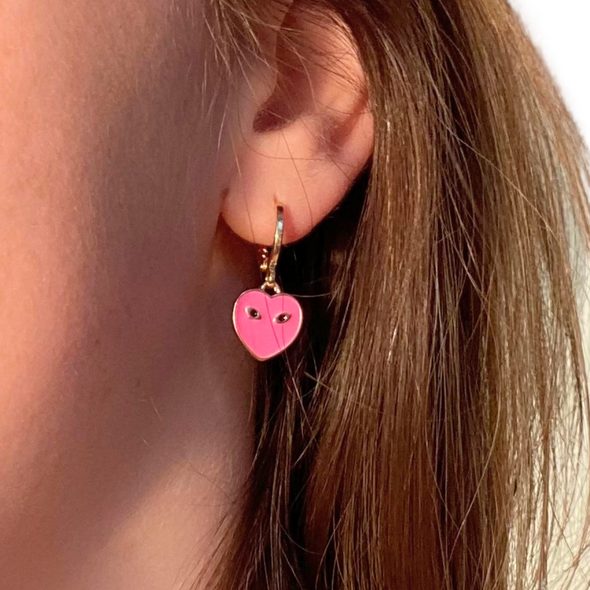 wearing Barbie Pink Mini Eye Heart You Huggie Hoop Earrings