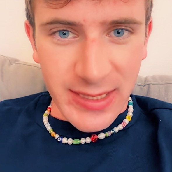 scott kress wearing let the good times roll y2k pearl and charm necklace