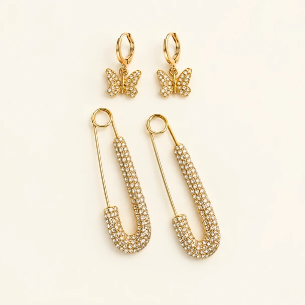 The Dolly Stack gold rhinestone safety pin earrings and glitzy butterfly huggie hoop earrings set