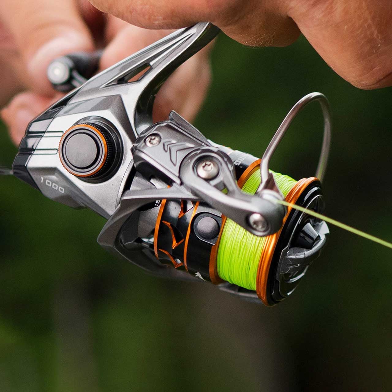 Live shot close up of hands using a KastKing Kestrel SFS Spinning Reel