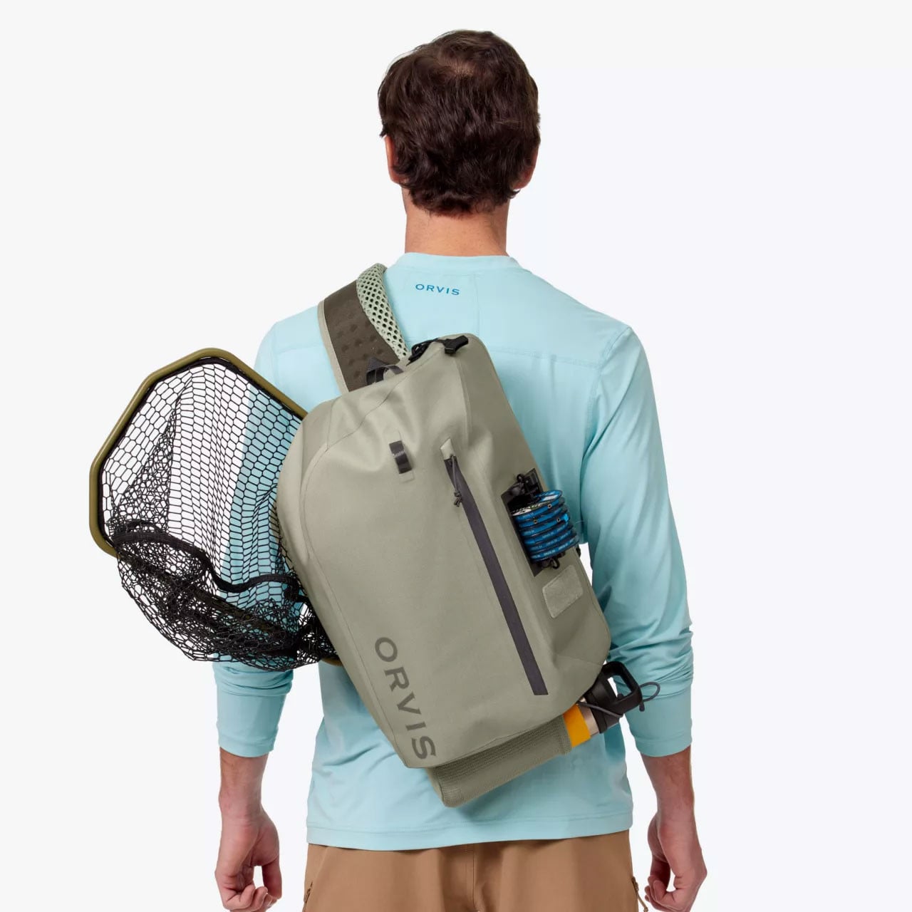 Back view of model wearing Orvis PRO Waterproof Sling Pack (landing net, tippet spools and water bottle are not included)