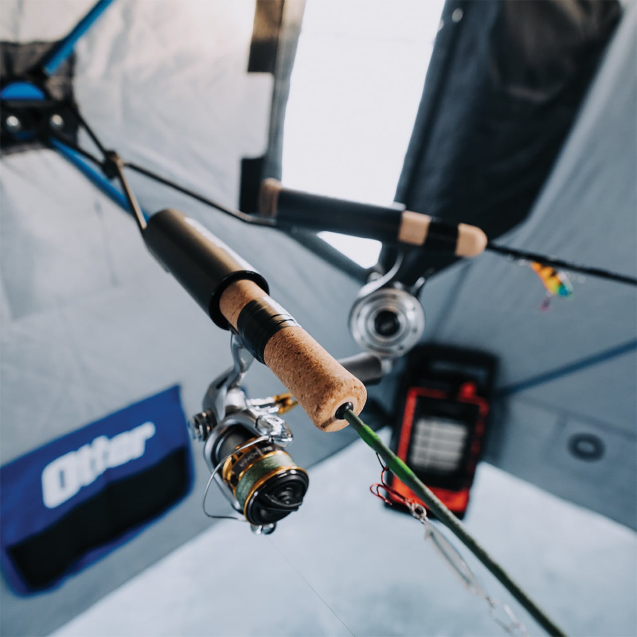 Otter Outdoors QA Dual Rod Holder demonstrating the grip on a pair of ice rods (not included)