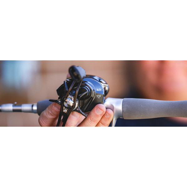 Daiwa Tatula SV TW70 Low-Profile Casting Reel presented at viewer's POV on a fishing rod and in an angler's hand